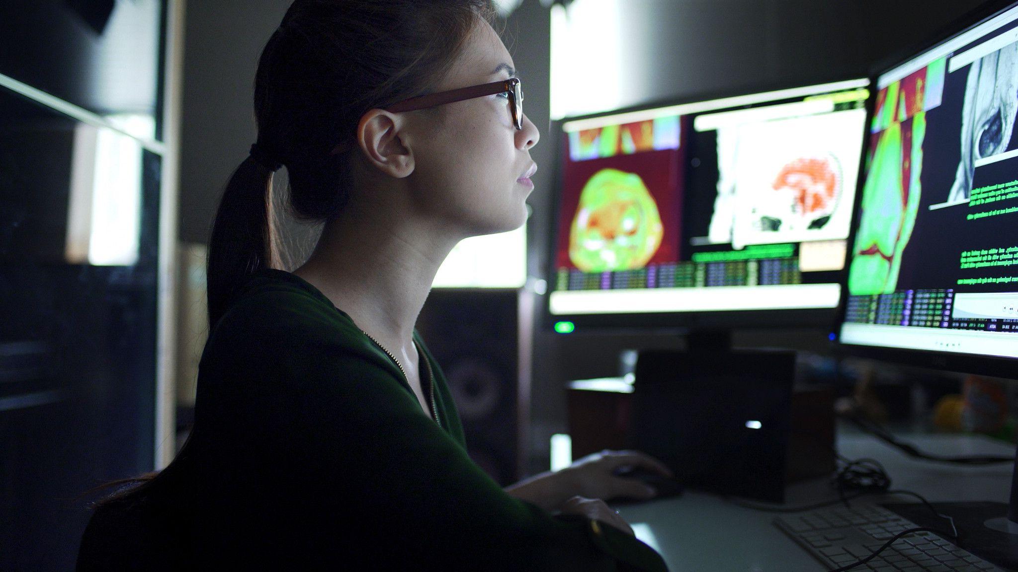 woman reviewing bio data on computers